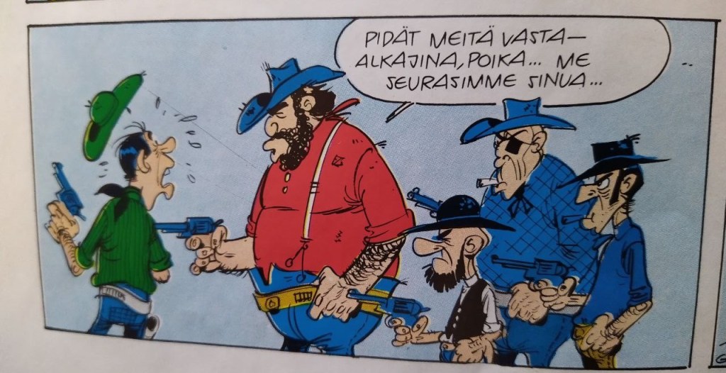 Sarjakuvan ruutu. Iso pörröpartainen Grubby Feller ja hänen joukkonsa, pieni partasuu, luihu laiheliini ja iso silmälappuinen osoittavat aseella vihreäpaitaista miestä. Grubby sanoo Pidät meitä vasta-alkajina, poika. Me seurasimme sinua.